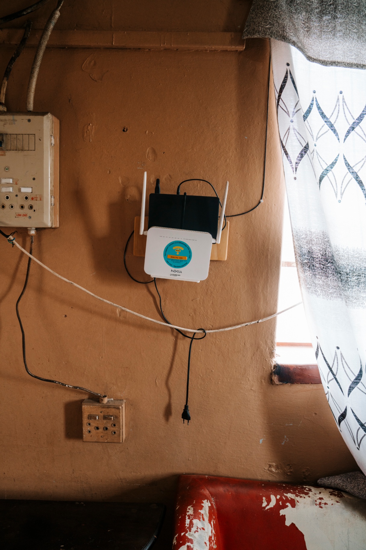 Fibertime router mounted on a painted interior wall in a township home