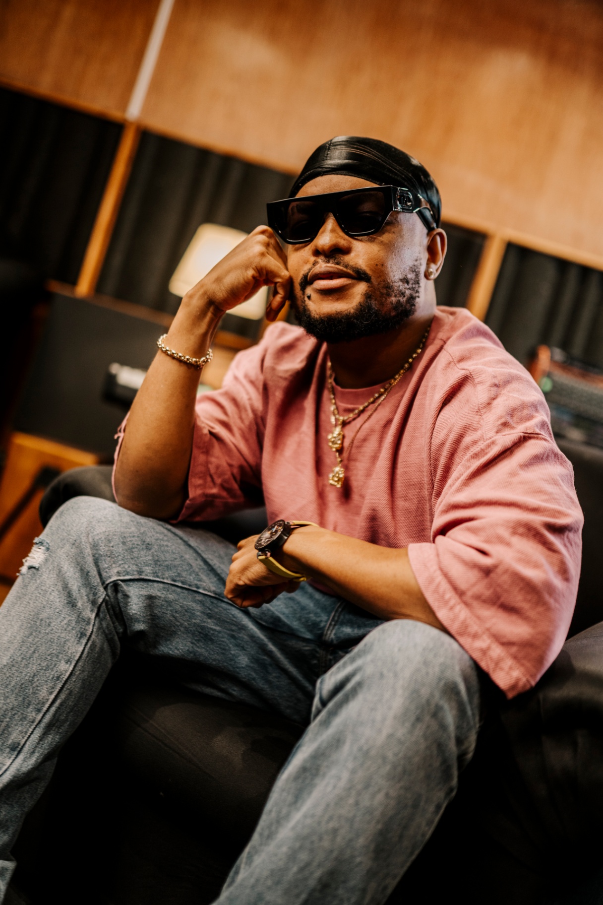 Artist KO seated in studio, portrait